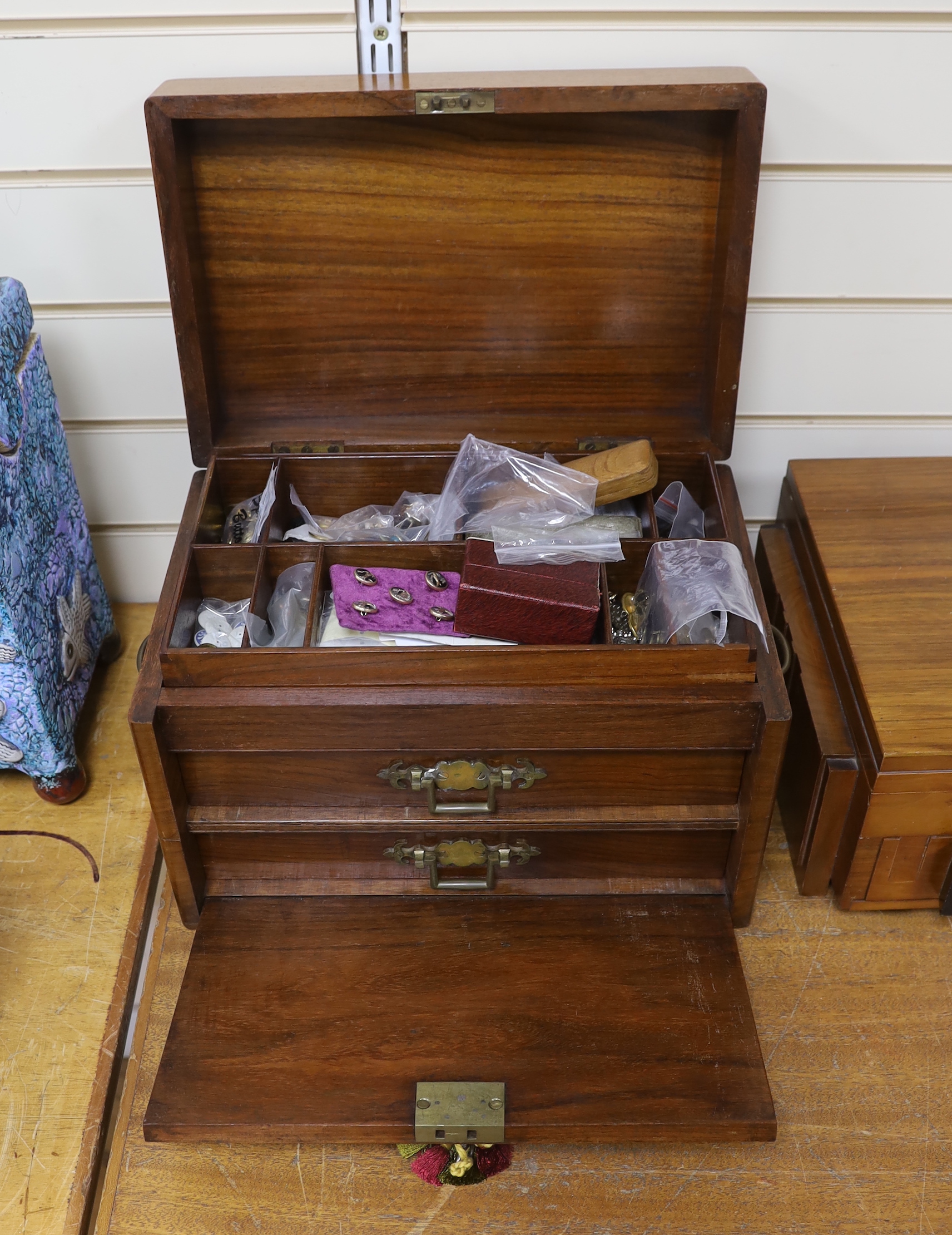 A Victorian mahogany work box, the interior with two drawers, housing a large collection of mostly buttons, a Japanese damascene gilt metal necklace and enamel studs, 42cm wide